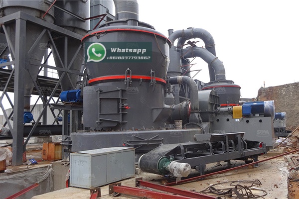 A large industrial Raymond Mill in operation within a mineral processing plant