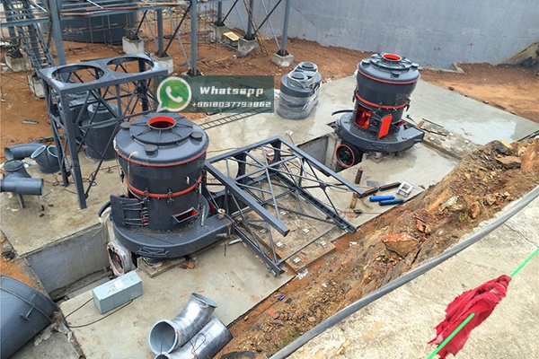 Diagram showing internal structure of vertical coal mill with grinding table, rollers, and hot gas flow