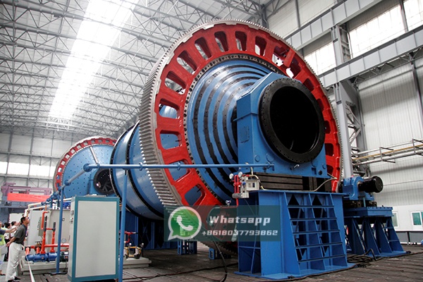 Technicians using precision instruments to align the girth gear and pinion on a ball mill