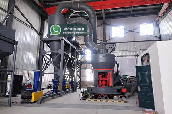 A large industrial grinding mill in operation inside a modern processing plant