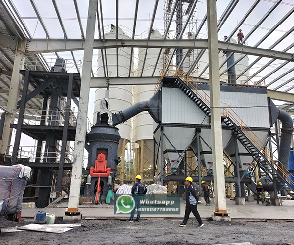 Maintenance technician accessing components on vertical grinding mill