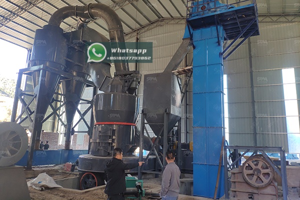 A modern industrial grinding mill in operation within a mineral processing plant