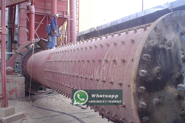 Marble quarry and initial crushing stage, showing large blocks of raw marble being fed into a primary crusher for size reduction before grinding